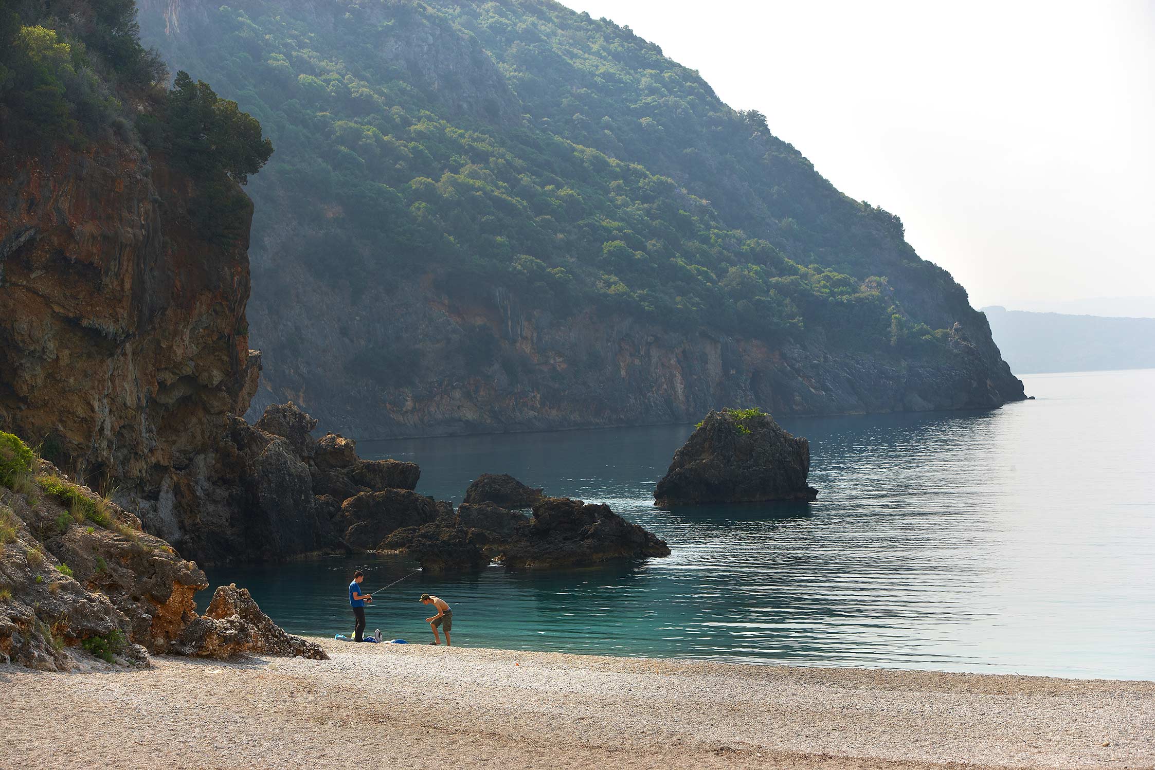 Lichnos Beach, two boys fishing at the beach