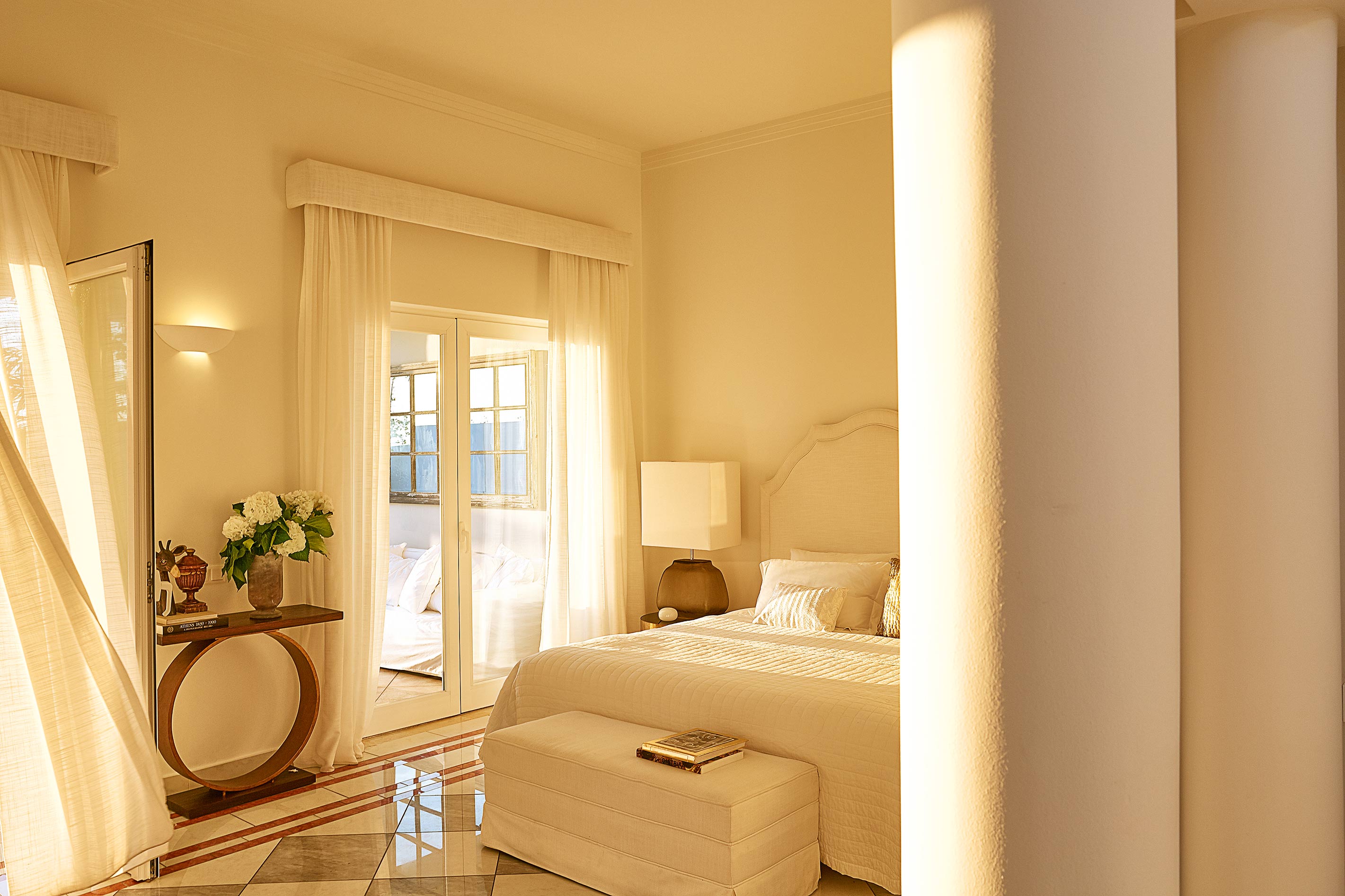 Grecotel Mandola Rosa villa bedroom in afternoon light with curtain moving