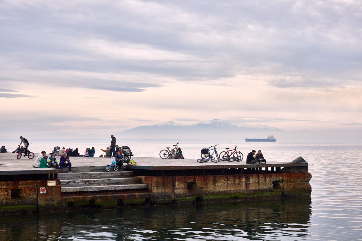 people gathering at paralia Thessalonikis in front of Mt Olymp