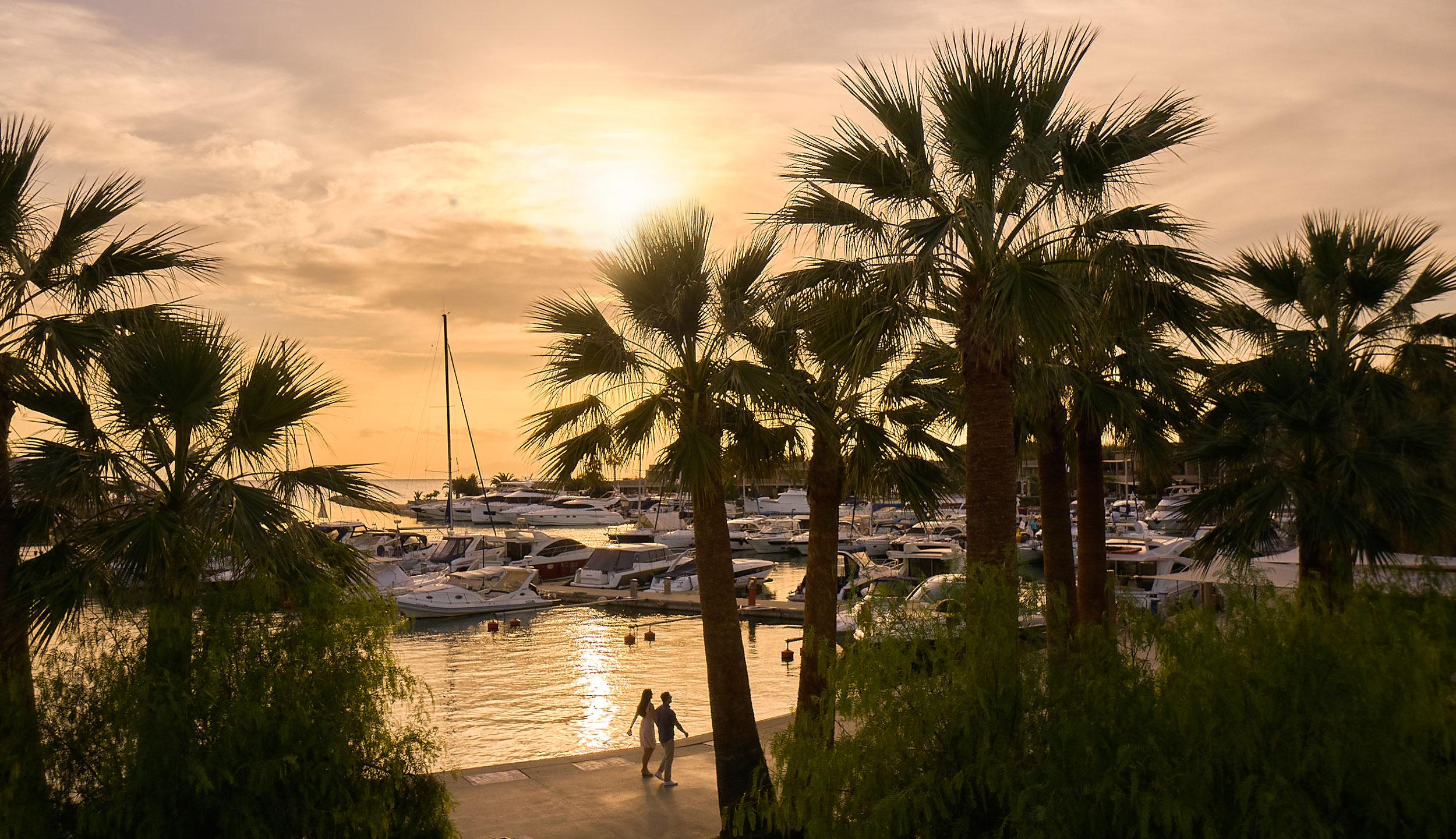 Porto Sani, marina, couple walking, sunset