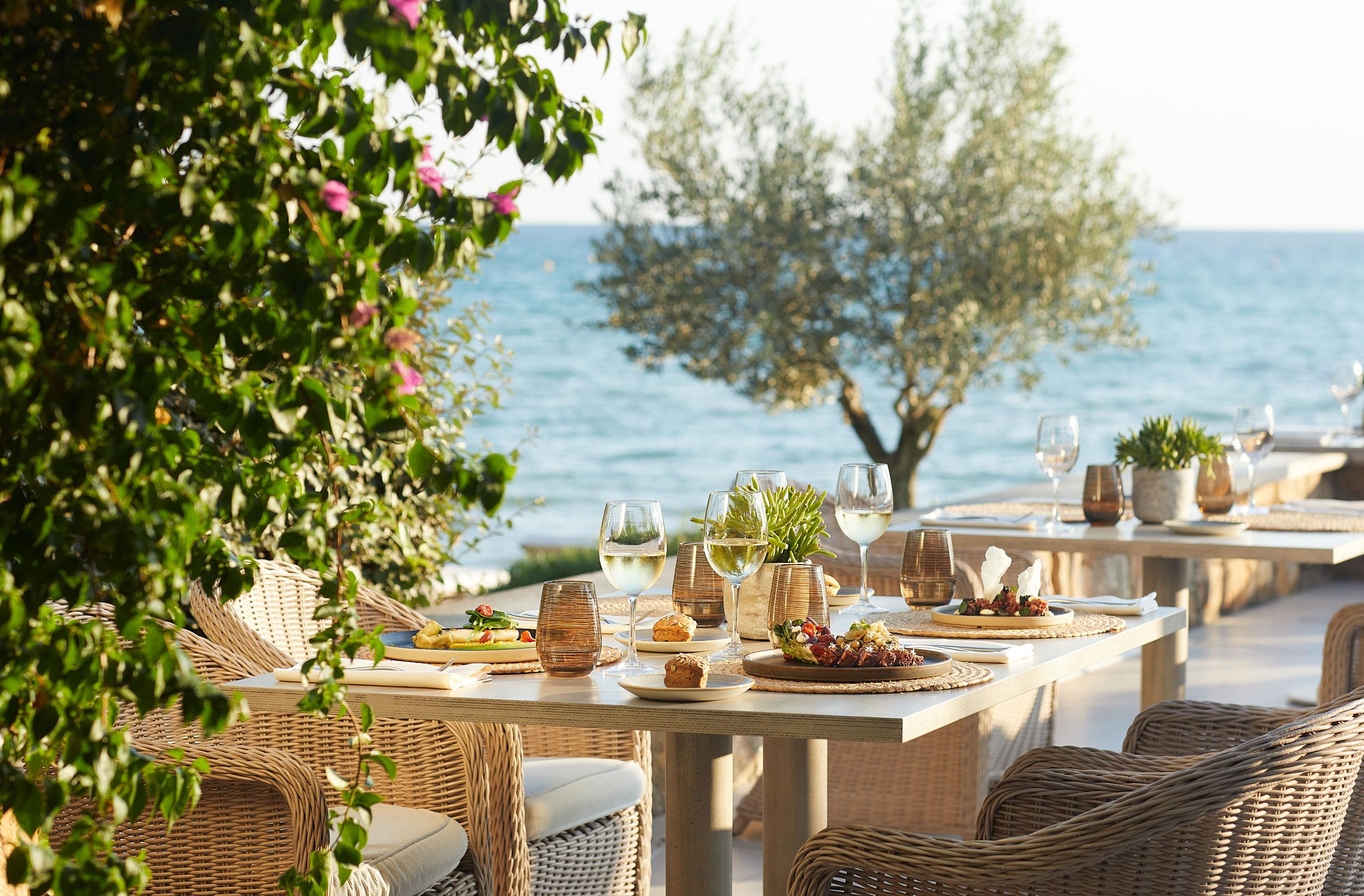 Sani Beach Ammos Restaurant, table set with dishes at the beach