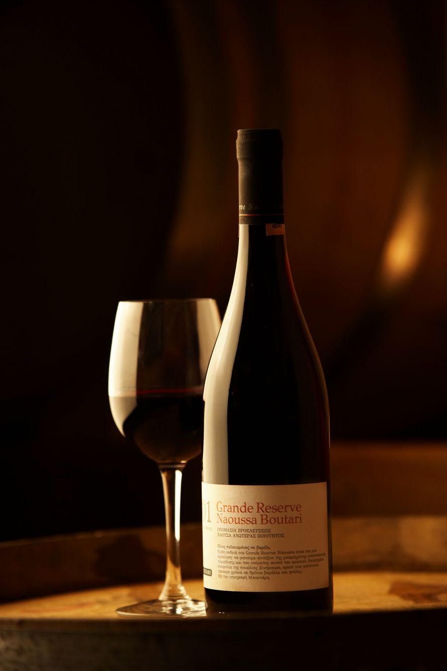Red wine Boutari Grand Reserve Naussa in winecellar with glass