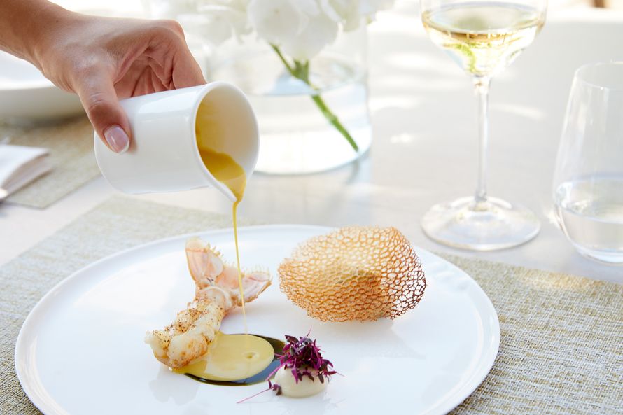 Sani Asterias Over Water, lobster tail, sauce pouring 