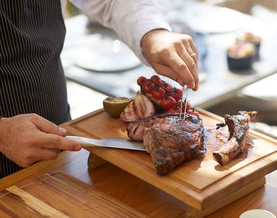 Sani Beach Grill by the Pool, chef cutting steak