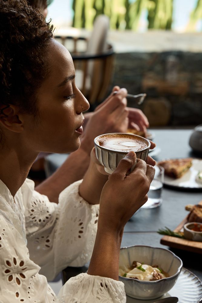 Daios Cove, lifestyle photo, girl drinking coffee