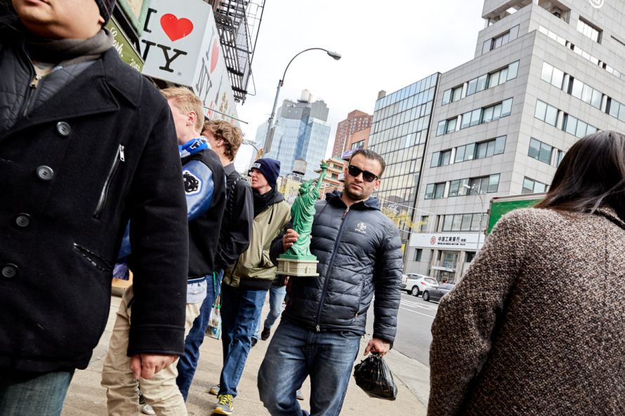 guy carries liberty statue in New York
